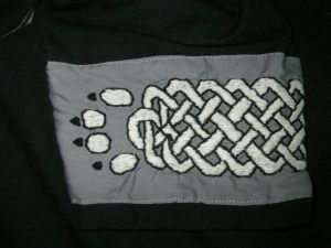 Embroidered Cuff. Simple knot work band with wolf toes. 